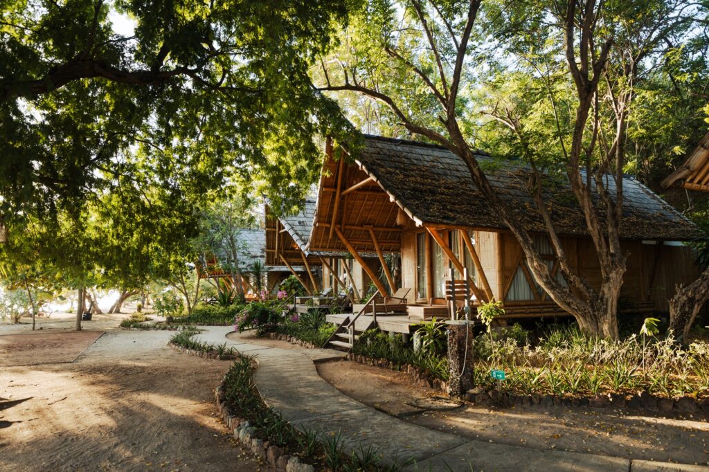 Beachfront bamboo bungalow beneath tamarind trees